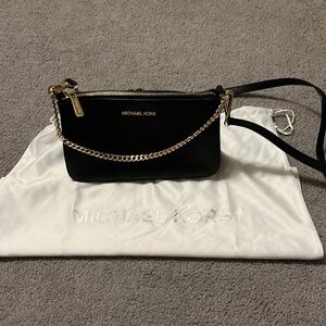 Excellent like new condition Michael Kors black and gold chain detail crossbody
